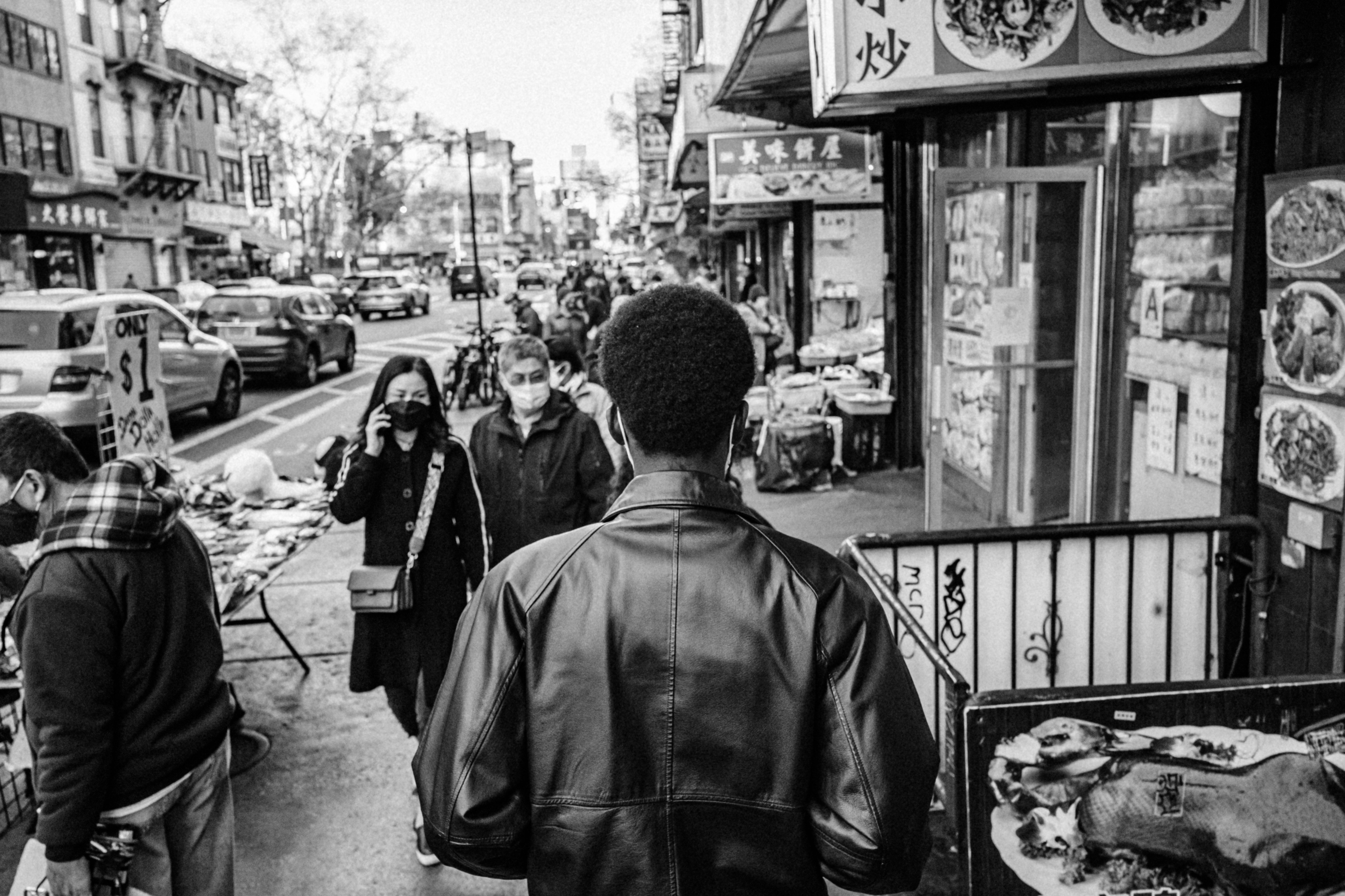 grayscale photo of people walking on sidewalk